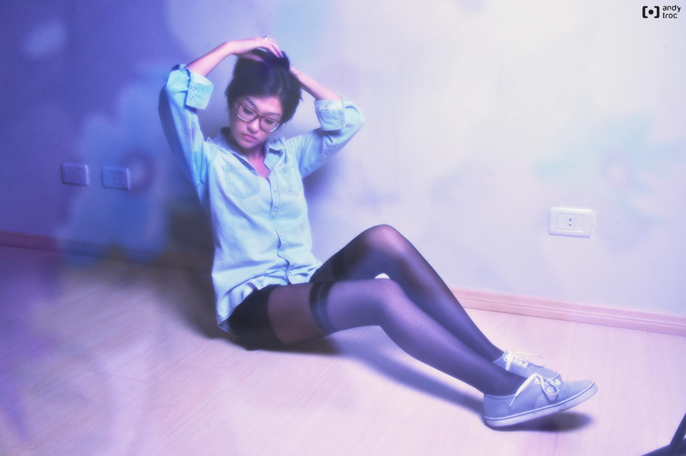 a woman in high school shorts and tights sits on the floor
