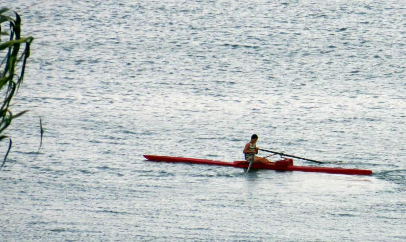 a person rowing a canoe through water