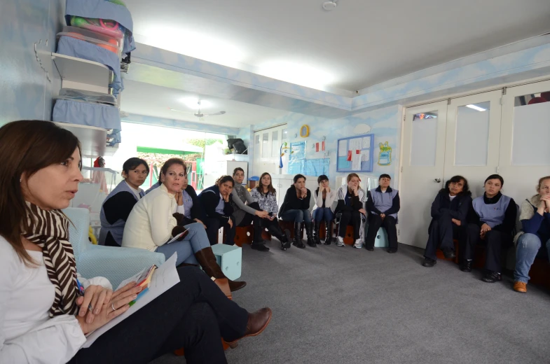 a group of people are sitting in an office