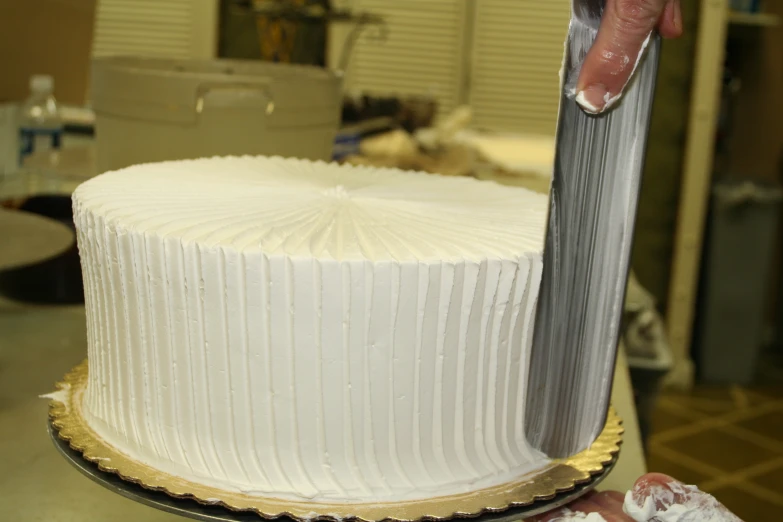 a cake being cut into by a person using a large knife