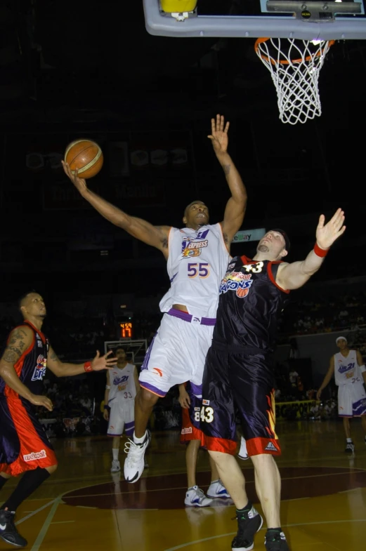 men playing basketball on a court at night