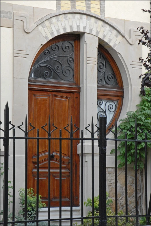 the door is surrounded by wrought iron fencing