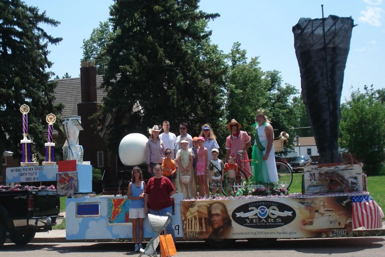 some people standing behind a float with decorations