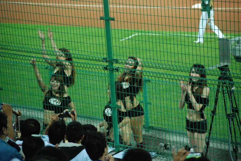 a group of people at a baseball field