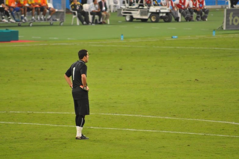 a soccer player standing in the grass during a game