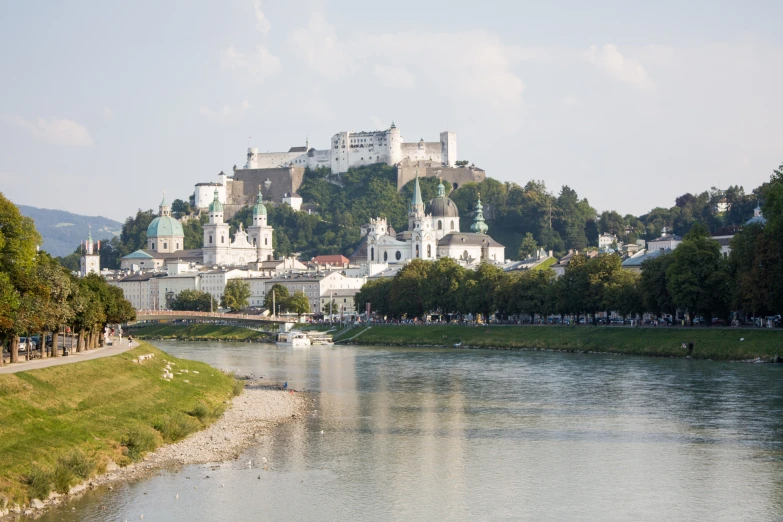 a body of water with a hill in the background