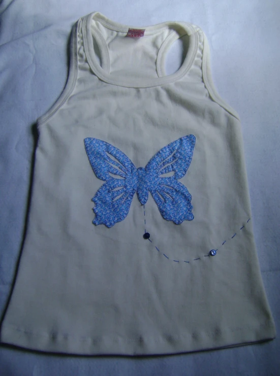 a blue erfly on a white shirt is shown