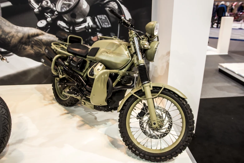 an old fashion motorcycle on display at an auto show