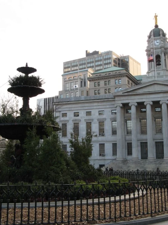 a white building with some tall buildings in the back ground