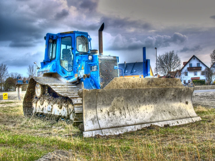 a large blue tractor in the grass