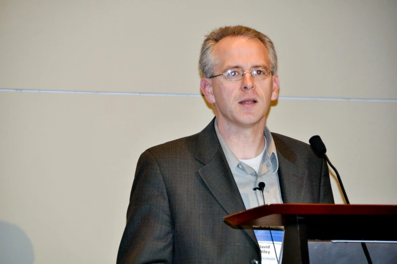 a man standing at a podium with a microphone