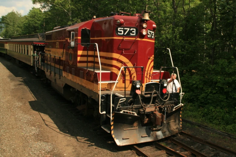 a man looking at the train on the tracks