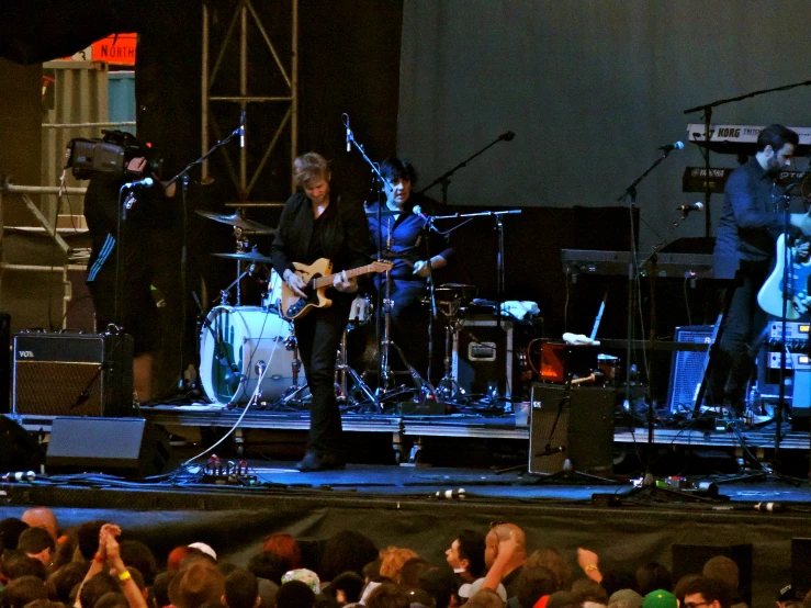 the band performing on stage with their instruments