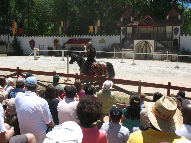 a man is riding a horse in an arena