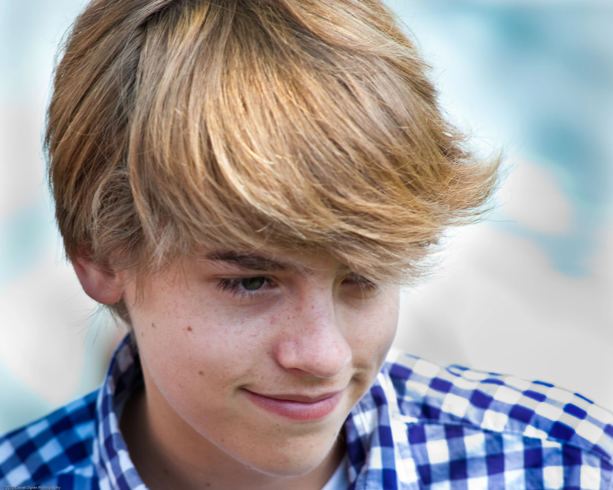 a boy wearing a shirt and tie with his head tilted back