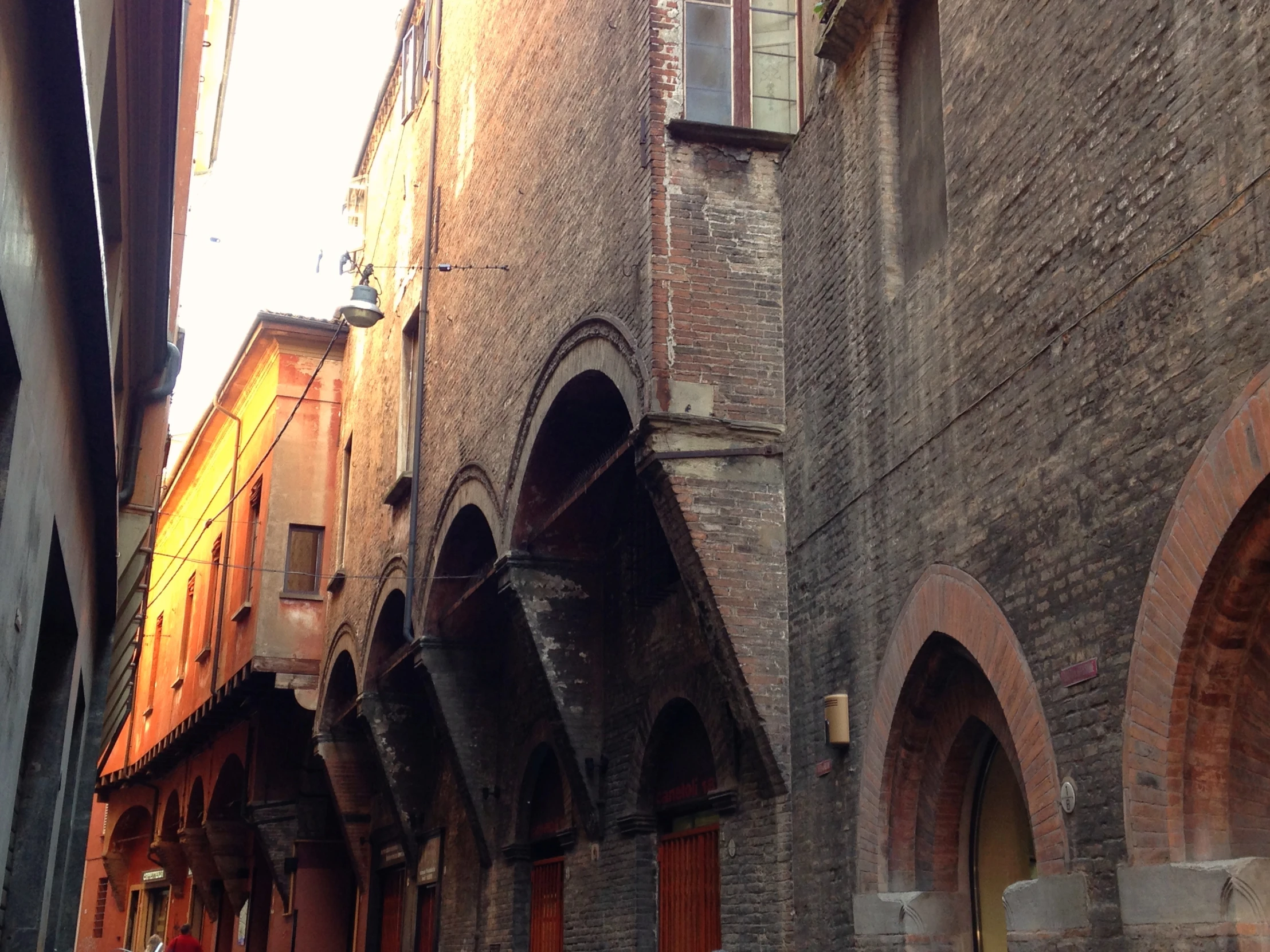 an empty alley with arched windows and doors