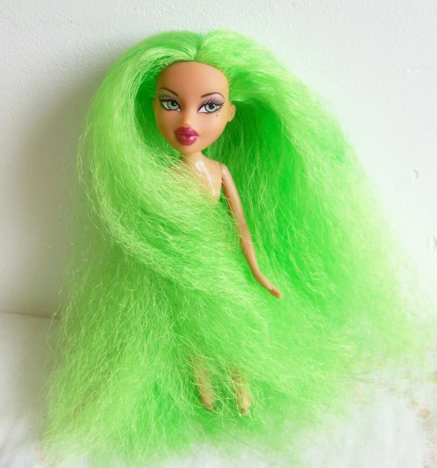 a green haired doll with light colored hair