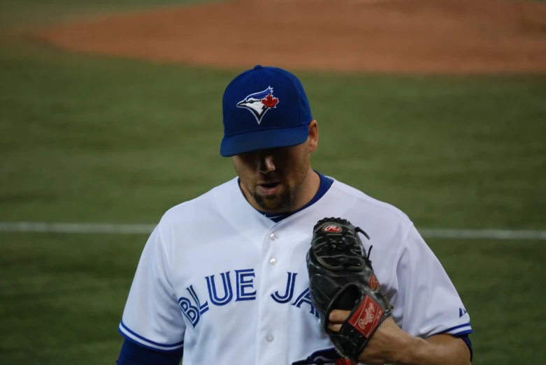 a baseball player with a glove is walking