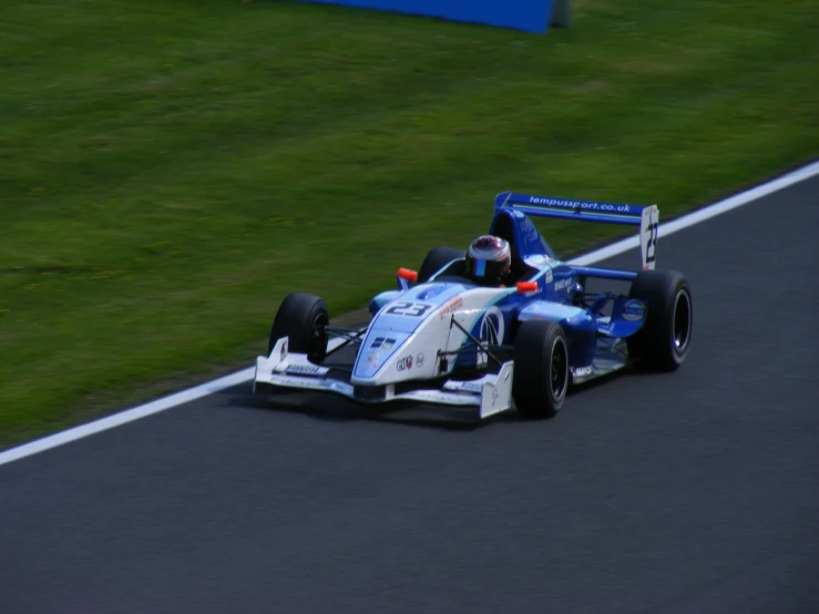 an image of a man driving a blue car on the road