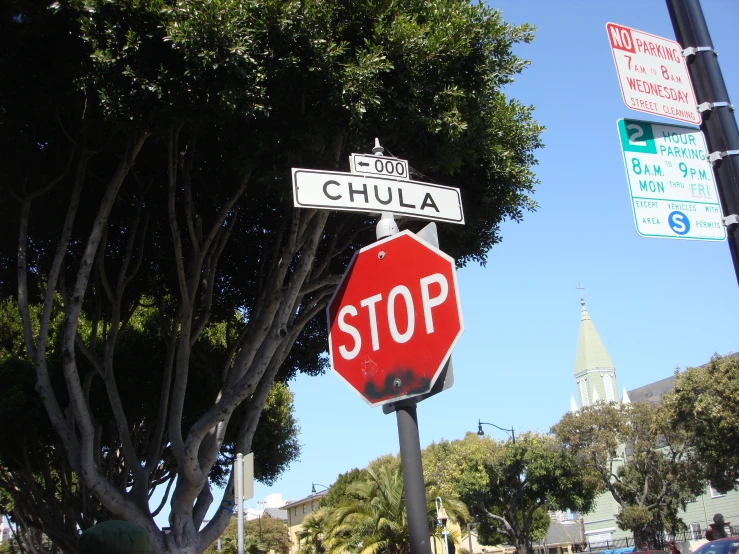 a stop sign on a pole by some street signs