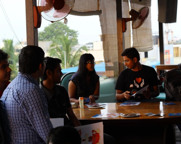 a group of people sitting around a table