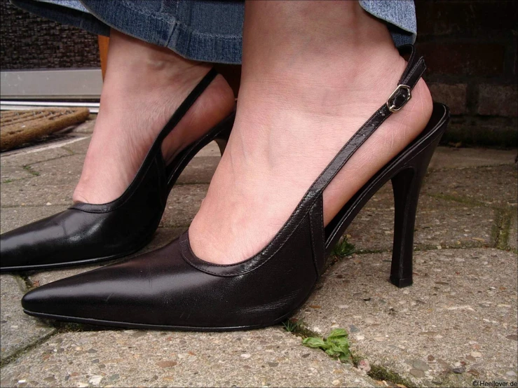 a woman with her foot on a high heeled shoe