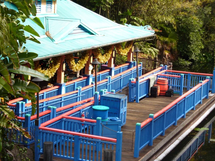 a blue fence is shown near a dock with orange and blue railings