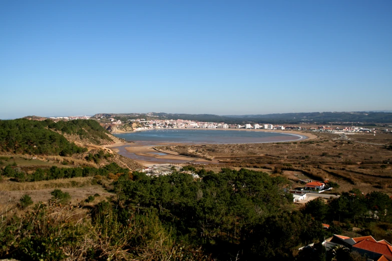 a picture taken from the hill looking down on the coastline