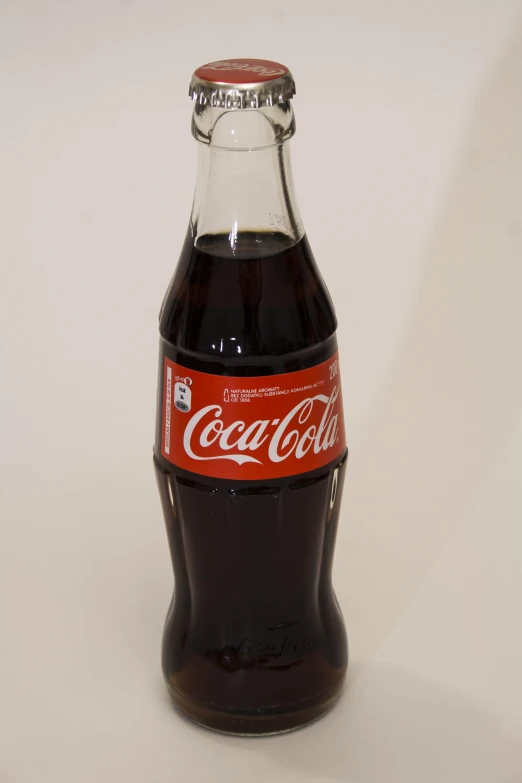 a coca - cola bottle with red labels on the front