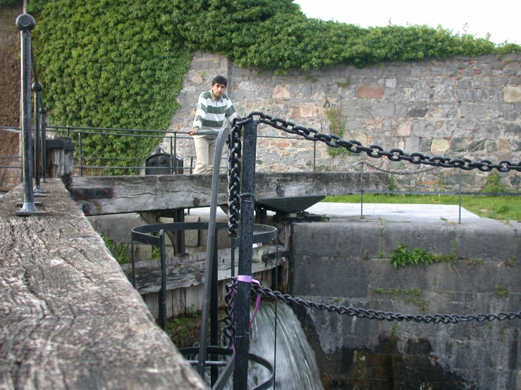 a man standing at the top of an old water well