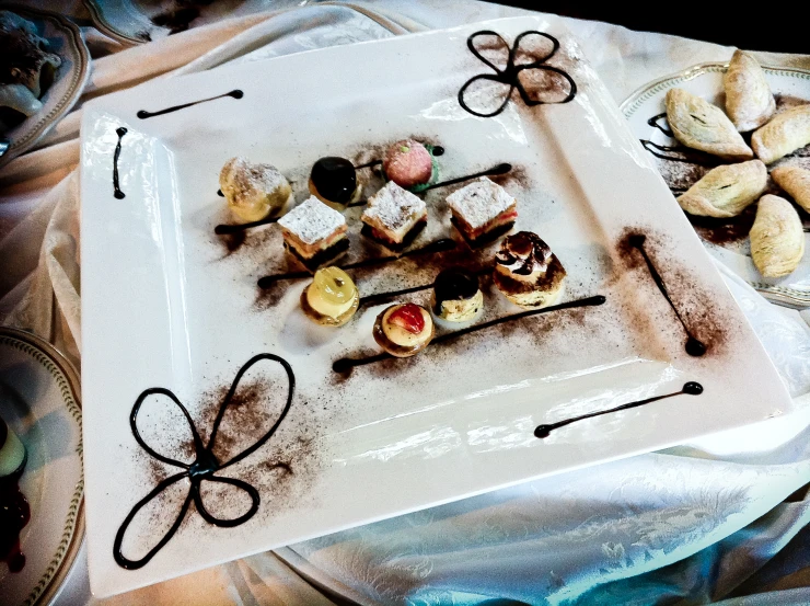 a white plate topped with food on top of a white cloth