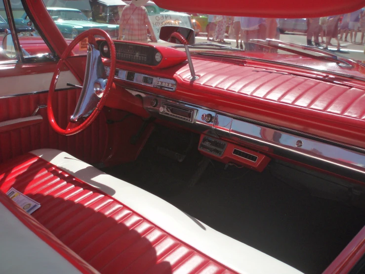 a red and white car interior with a red dash board