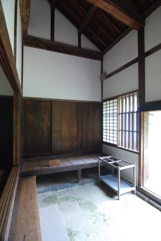 a japanese house with a bench and table by the window