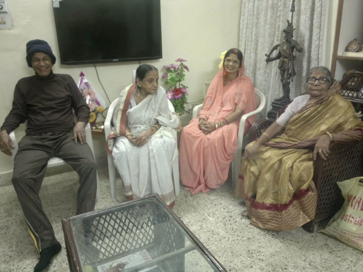 a group of people sitting down together in a living room