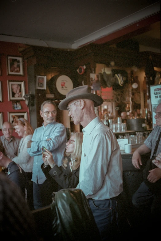 a group of people talking and having drinks at a bar