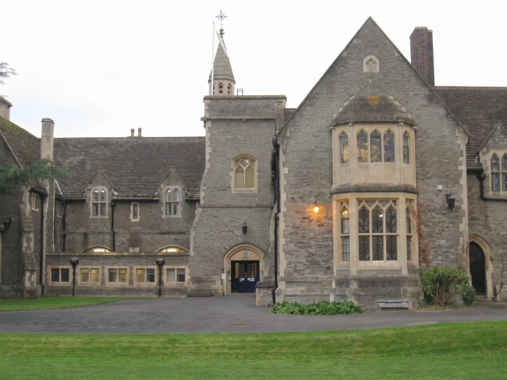 an old building that has a clock on the front and tower