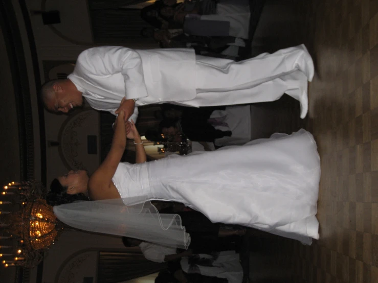 a bride and groom dancing together at their wedding reception