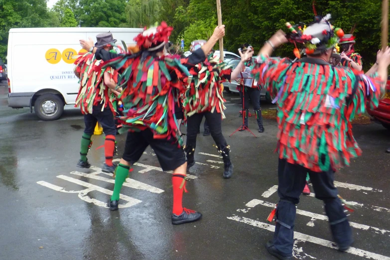 a group of people dancing around on a street