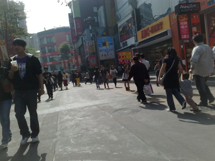 a crowded street with pedestrians and people walking