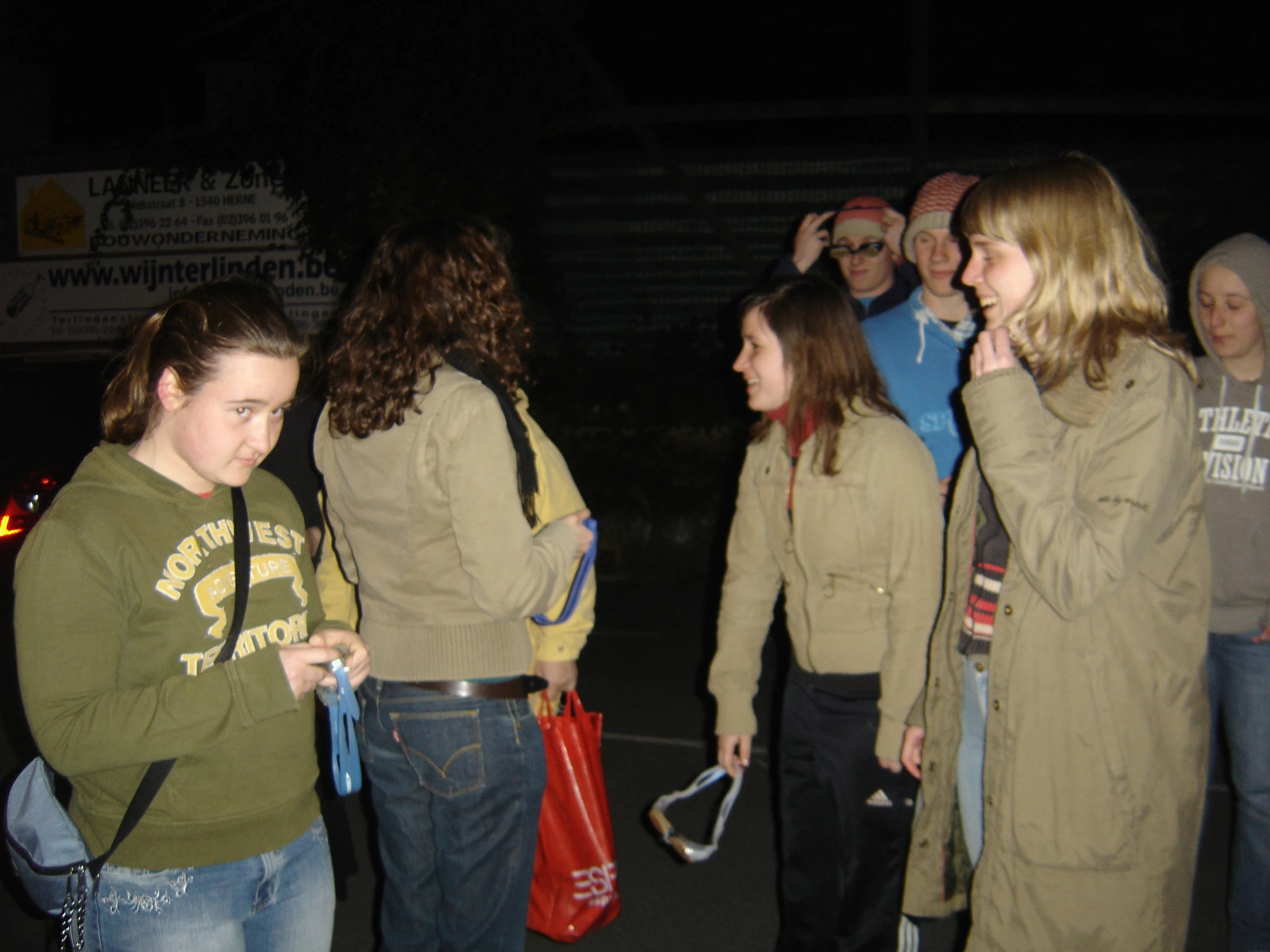 a group of people stand outside and talk