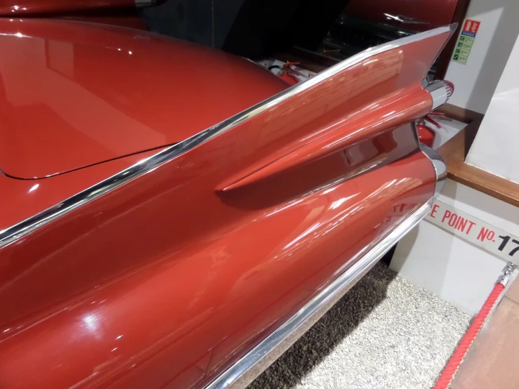 an old red car in an automotive showroom