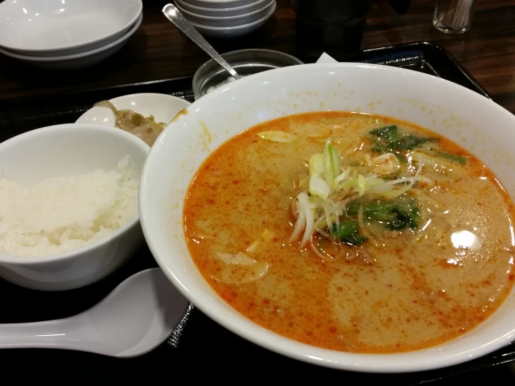 an asian soup with broccoli sits on a plate