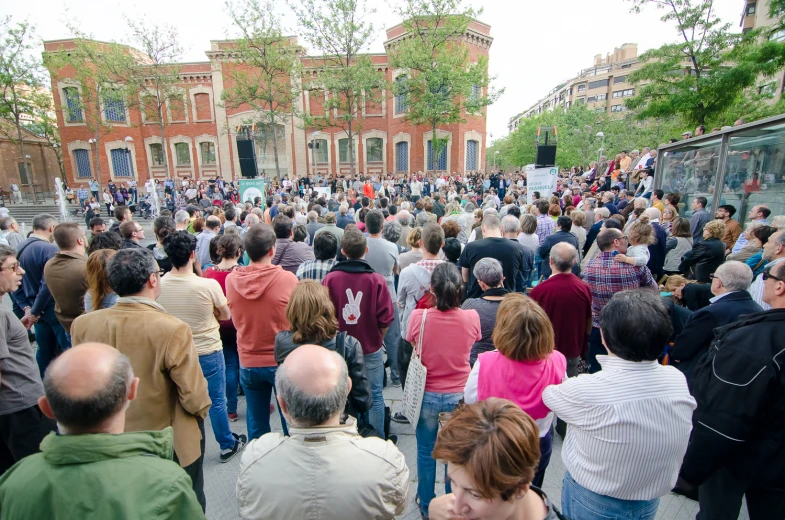 a crowd of people walking down a sidewalk