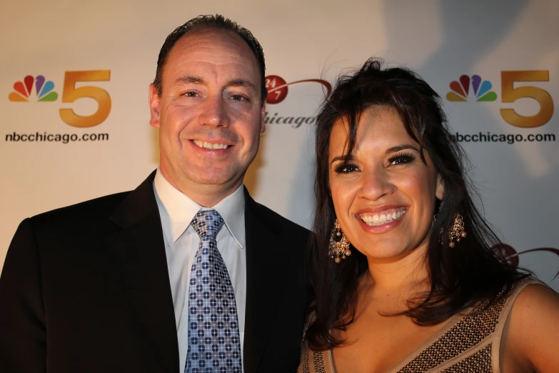 a man and woman posing for a picture on the red carpet