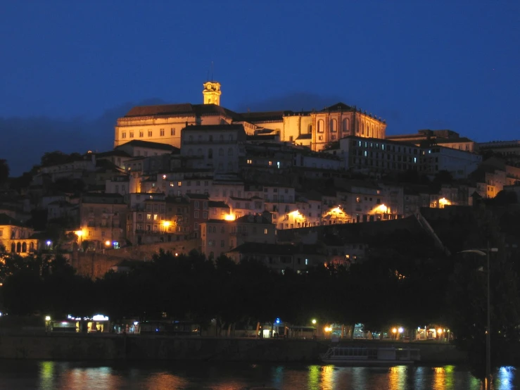 the night view of a large old city with lights at dusk
