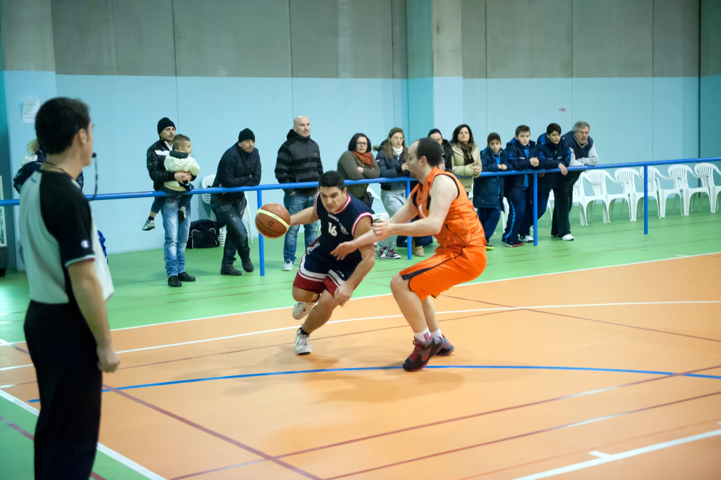 a couple of people standing on a basketball court