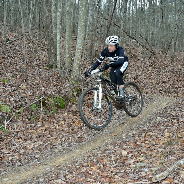 a man riding a bike through the woods