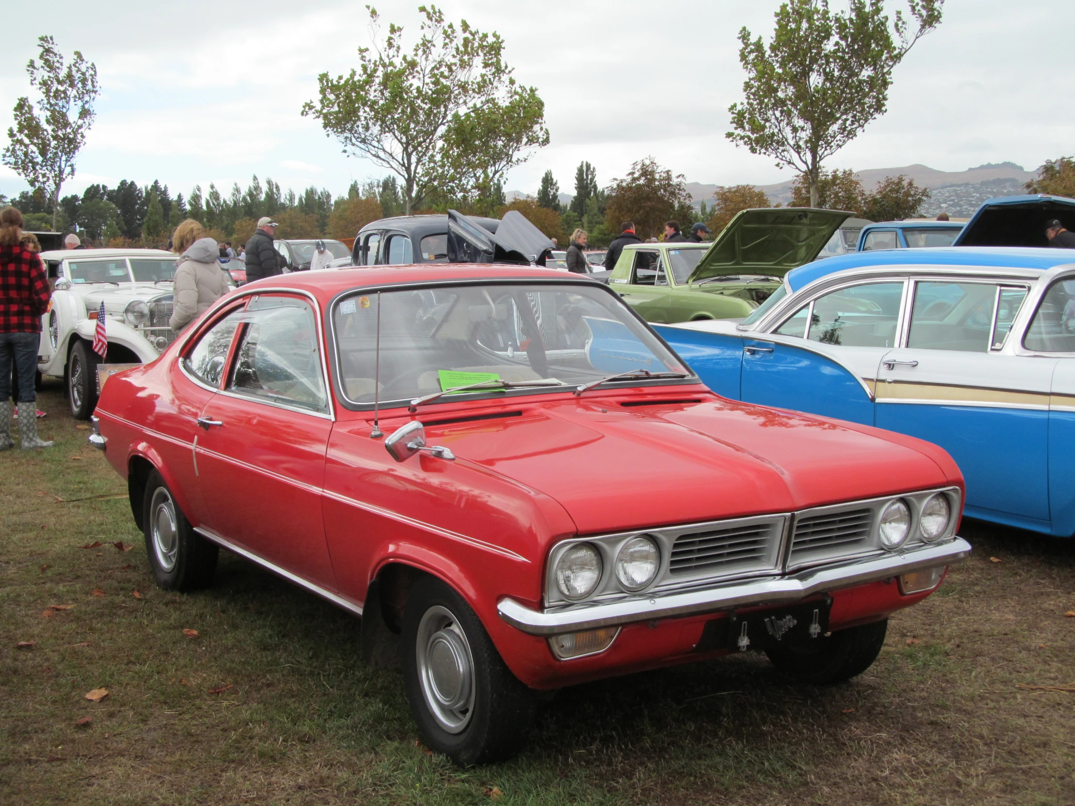 old cars parked near each other in a field