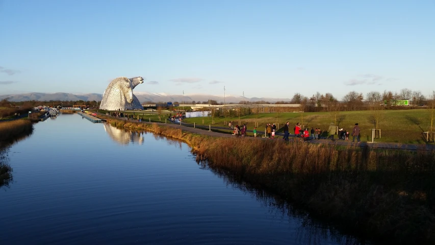 a boat is traveling on the river near some people