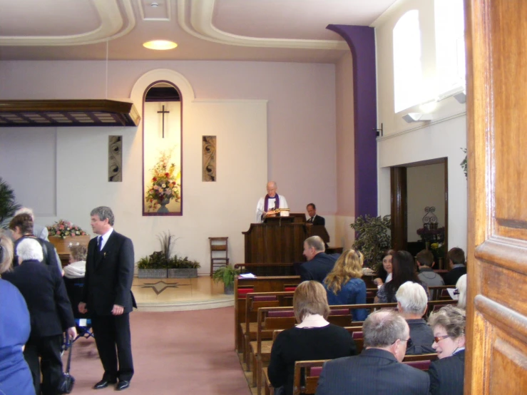 a group of people in a church sitting in pews